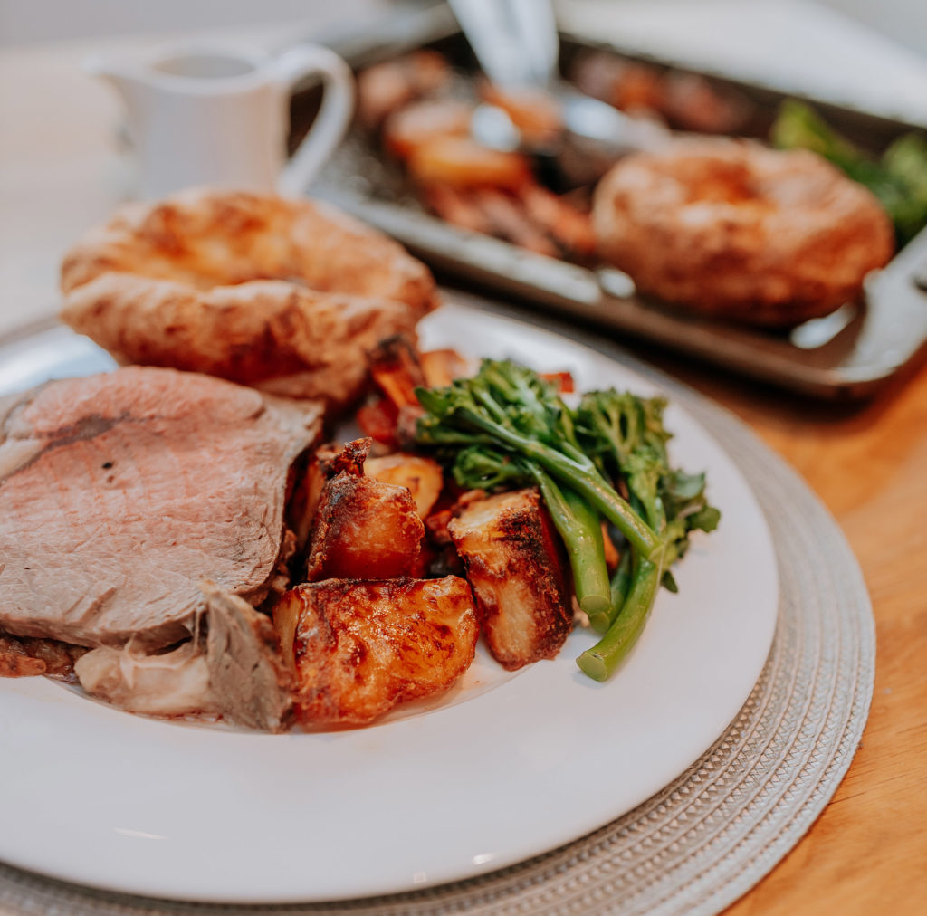 A traditional Sunday roast dinner served on a white plate
