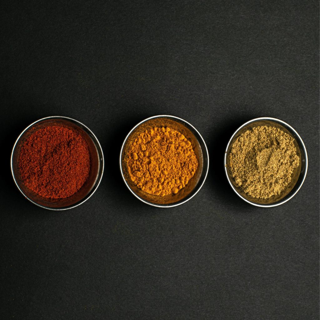 Three bowls of colourful spices - examples of the sort of ingredients used during an international cookery course at Swinton Cookery School near Harrogate in North Yorkshire