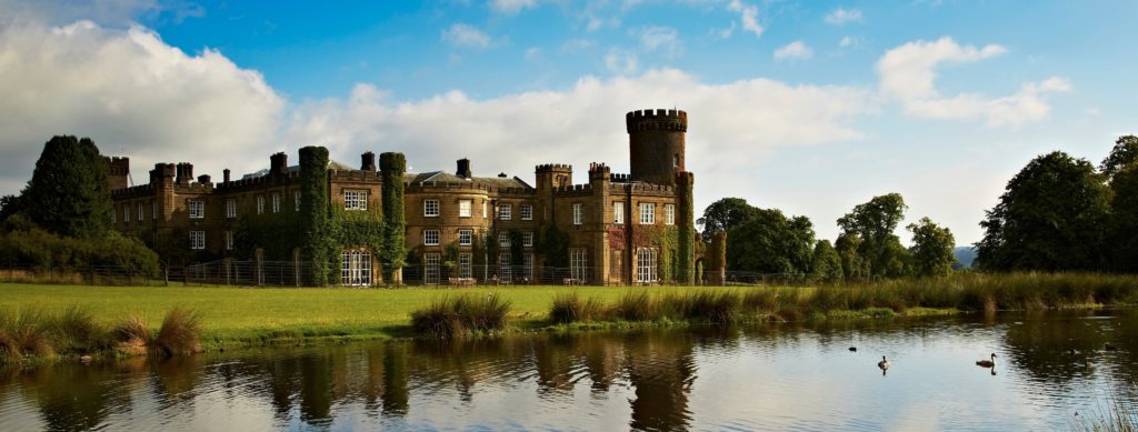 External photo of Swinton Park castle hotel with lake