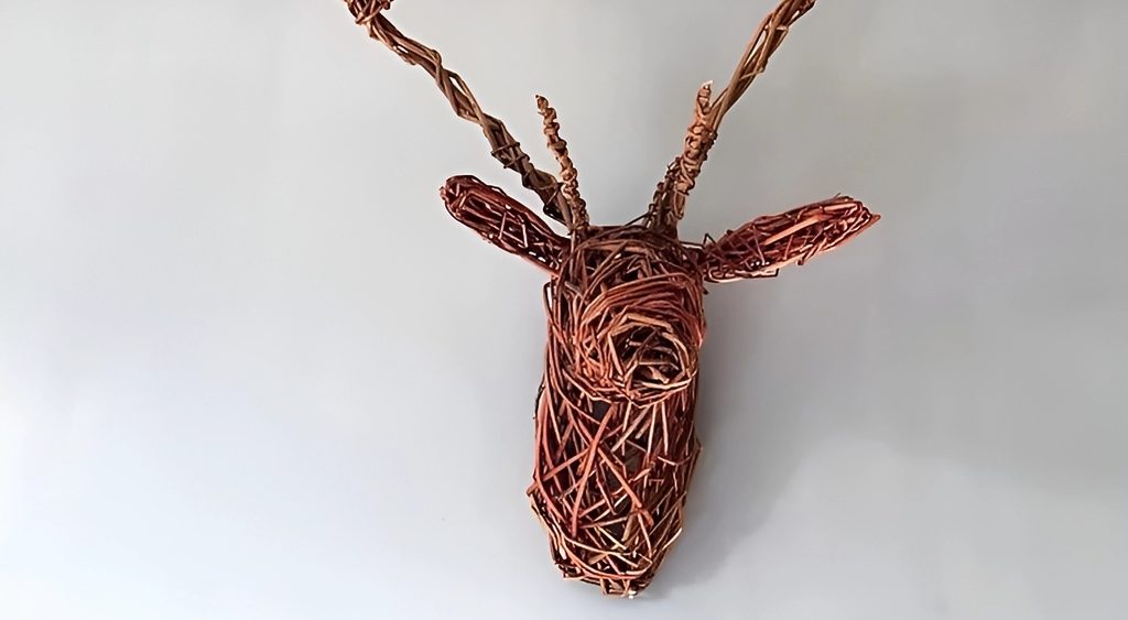 A decorative stag head made from willow