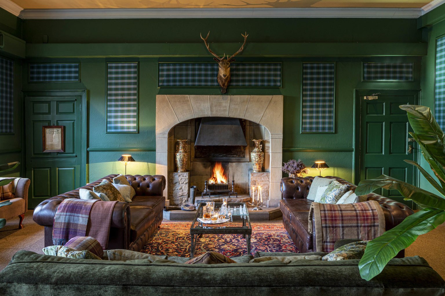 Sofas and fireplace in the Billiards Room at Swinton Park castle hotel on the Swinton Estate near Harrogate and the Yorkshire Dales