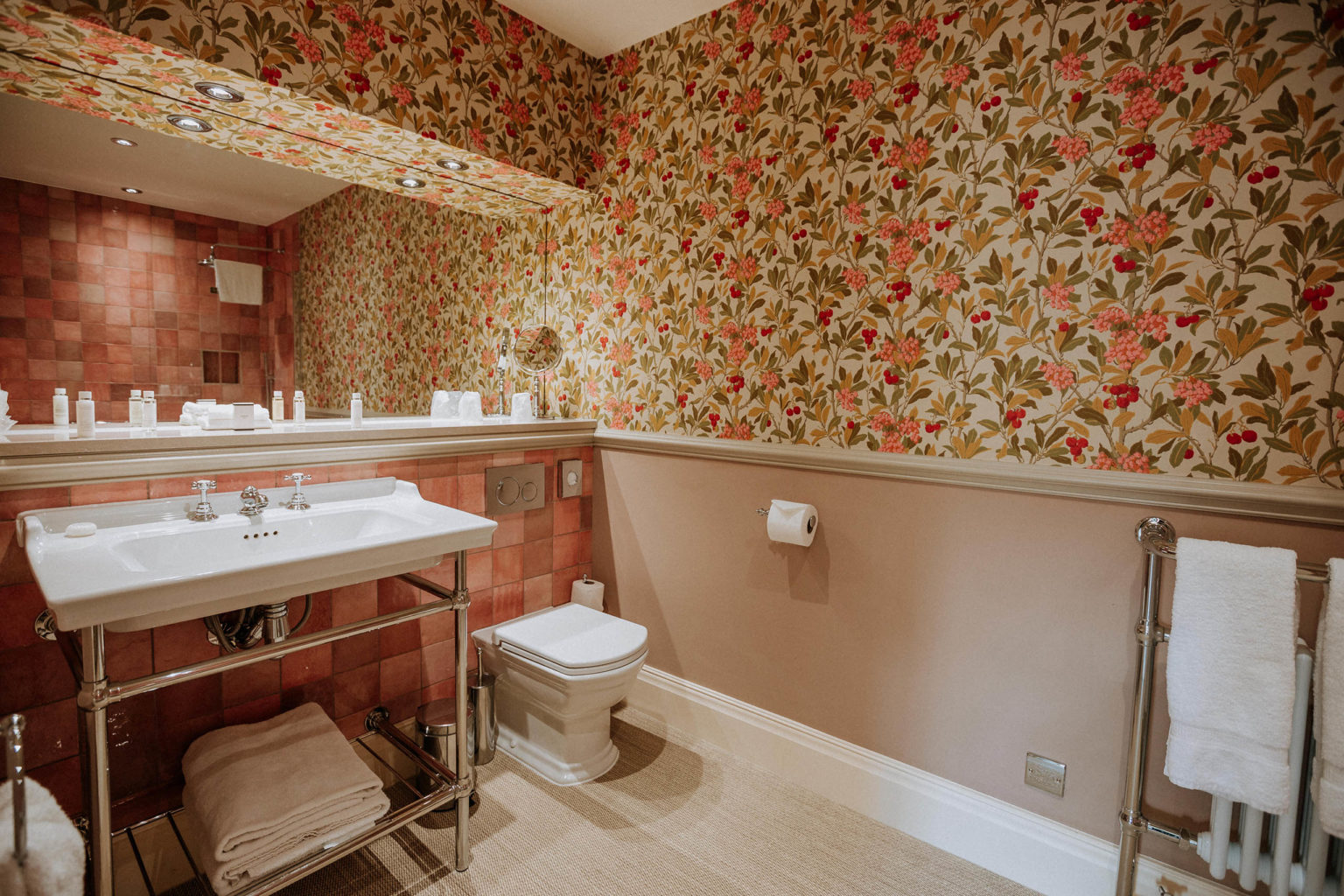 The toilet and sink in the Fearby bedroom at Swinton Park Hotel in North Yorkshire