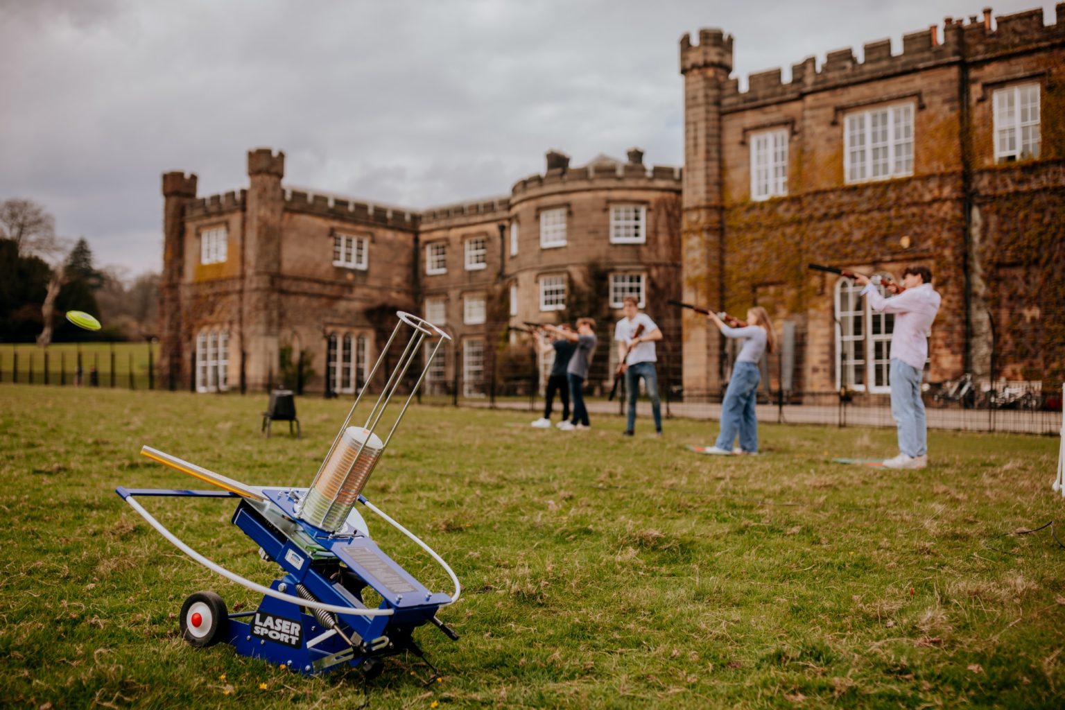 A family doing laser clay shooting at Swinton Park Hotel in North Yorkshire