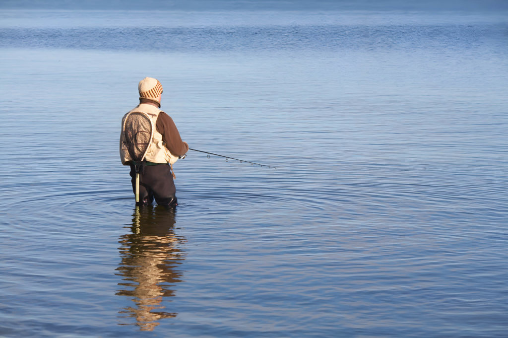 A man fishing in a reservoir in Yorkshire