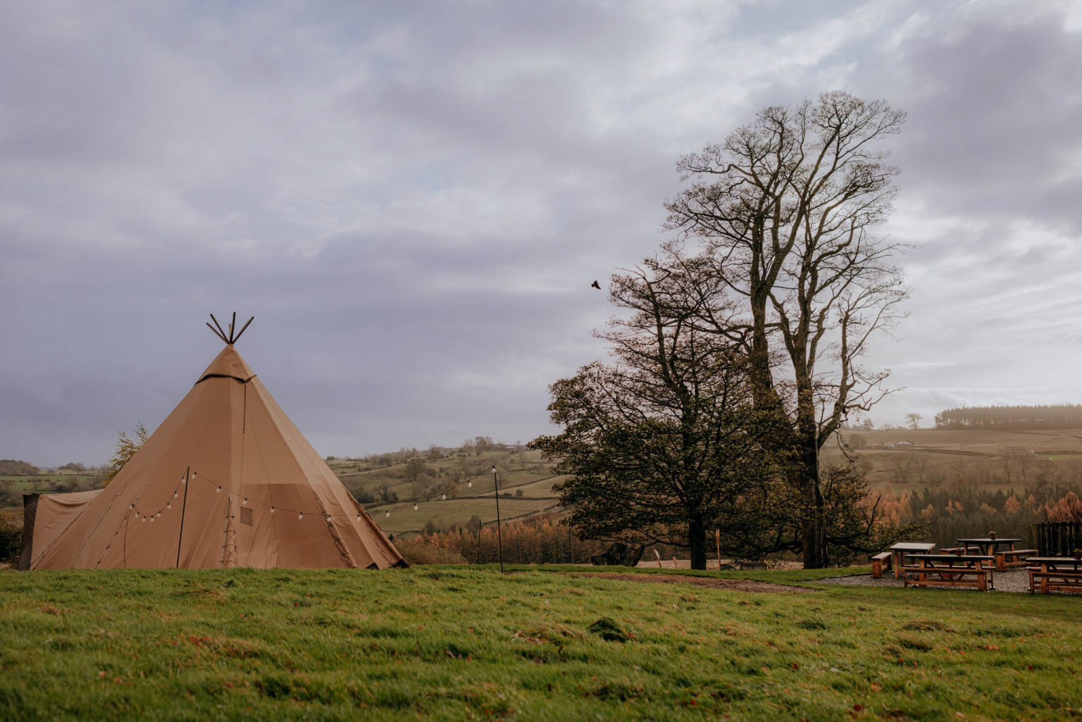 Tipi outside in a field at Swinton Bivouac in North Yorkshire