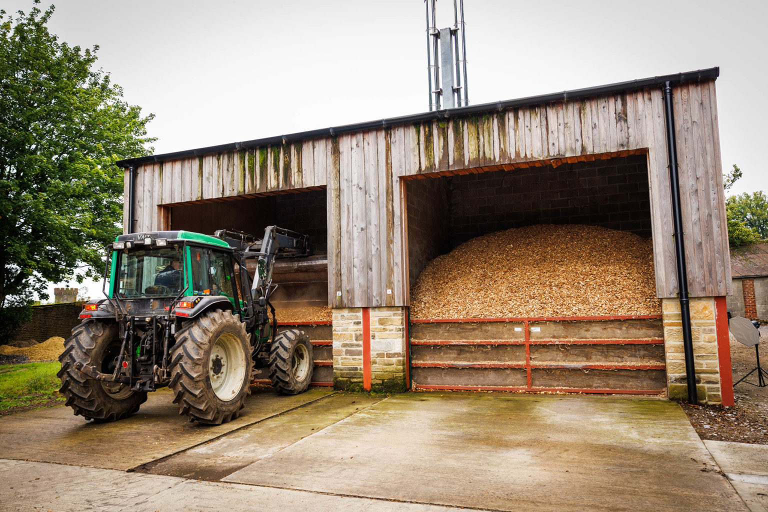 A tractor moving biomass wood chips on the Swinton Estate