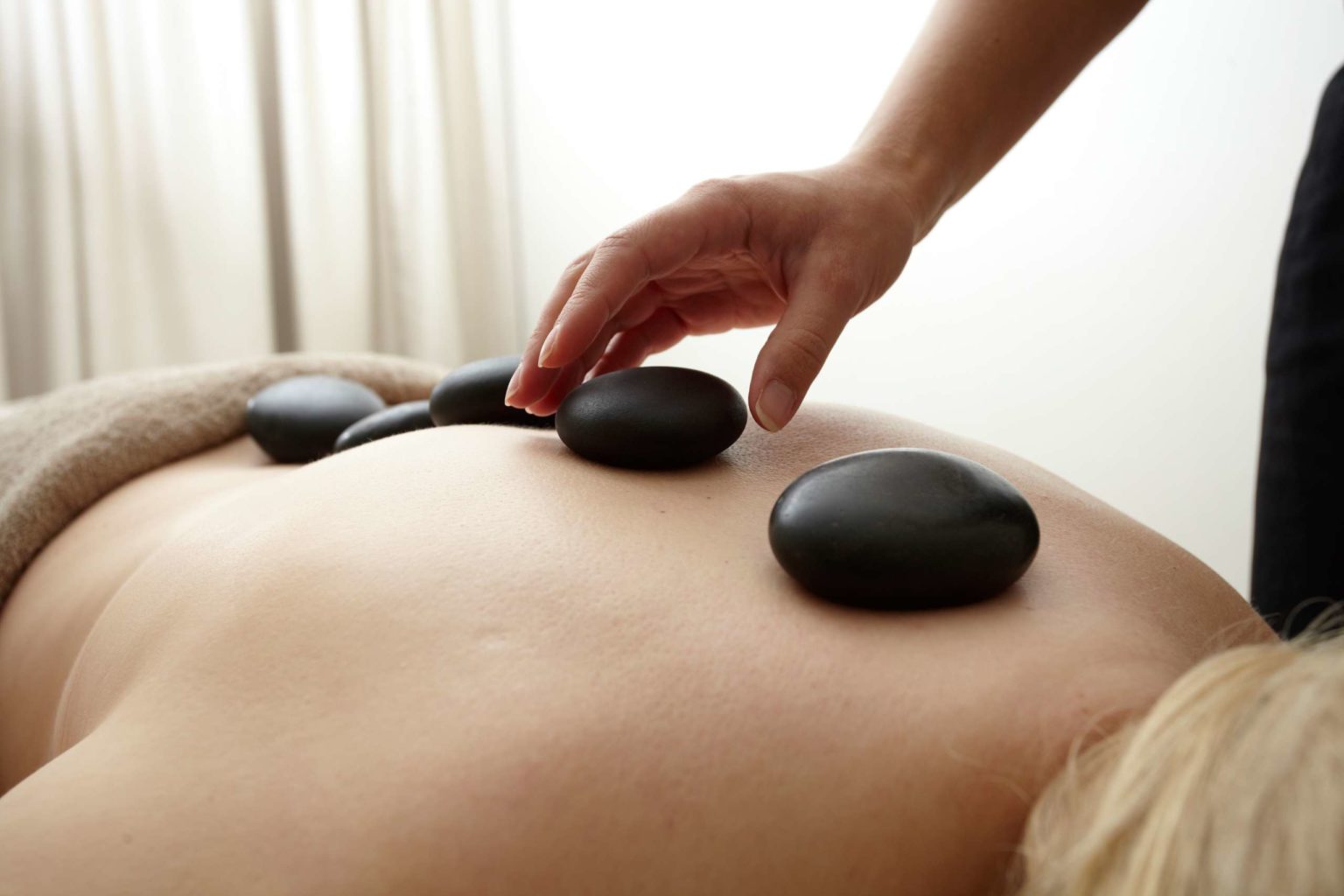 Someone getting a hot stone massage during a spa day treatment in North Yorkshire