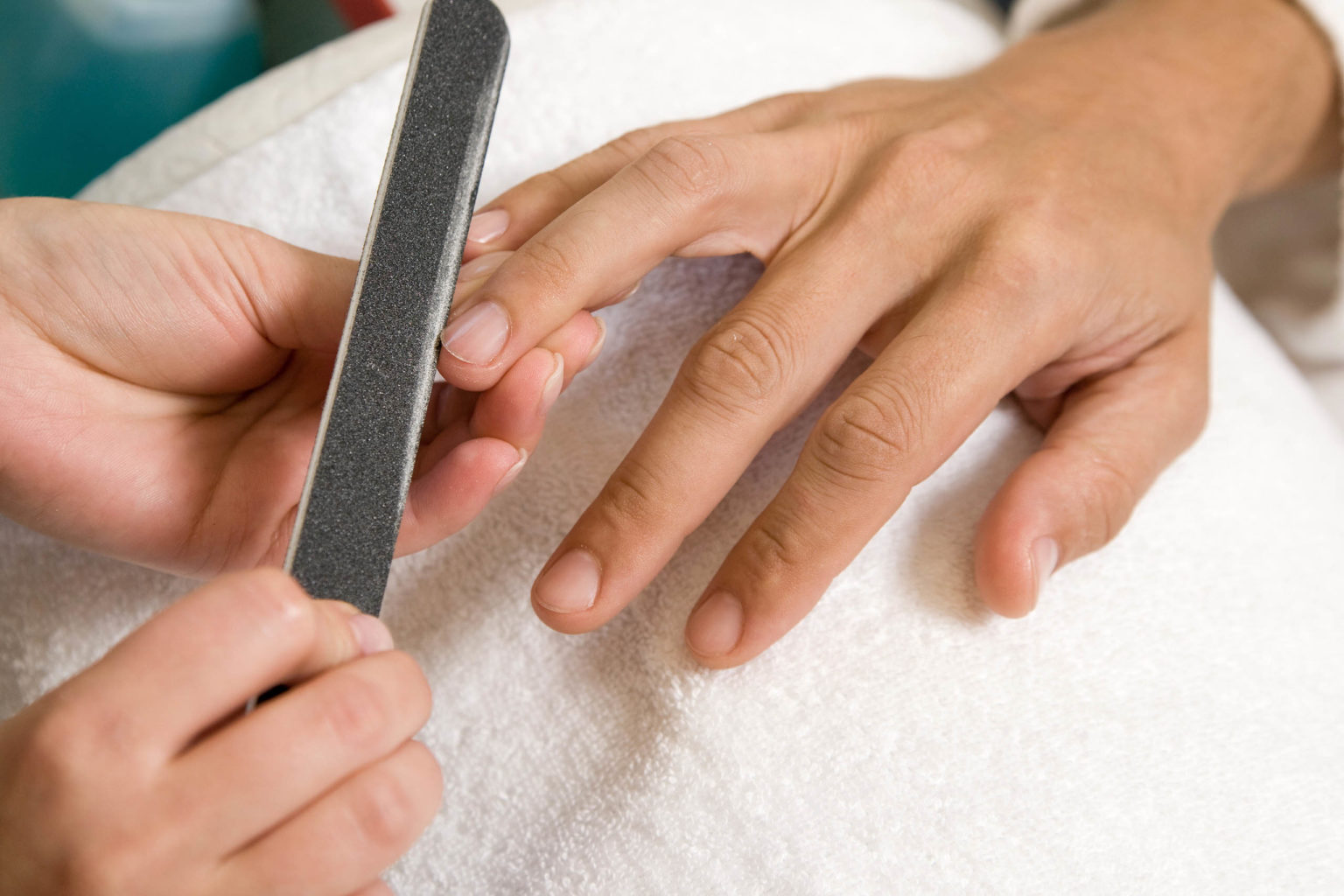 Closeup of a man getting a manicure in a spa