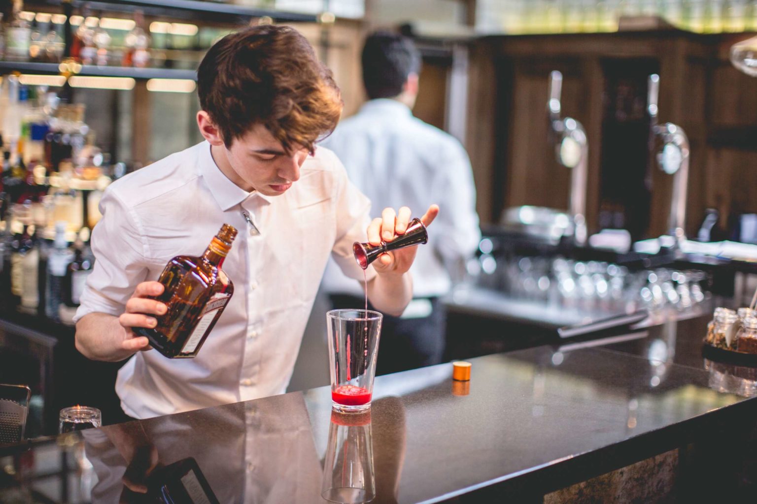 A barman creating a cocktail in The Terrace Restaurant and Bar