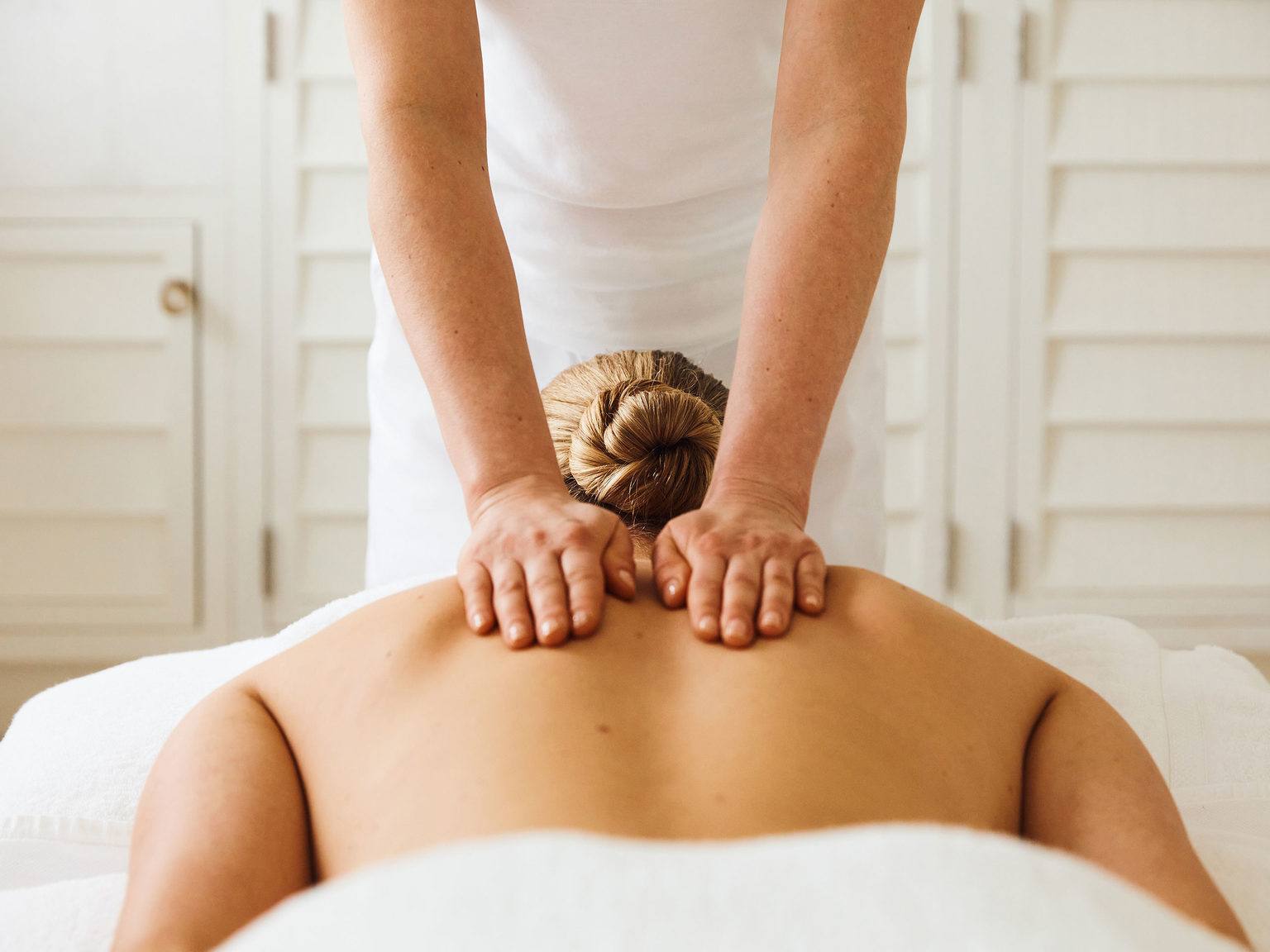 A woman having a back massage during a spa day