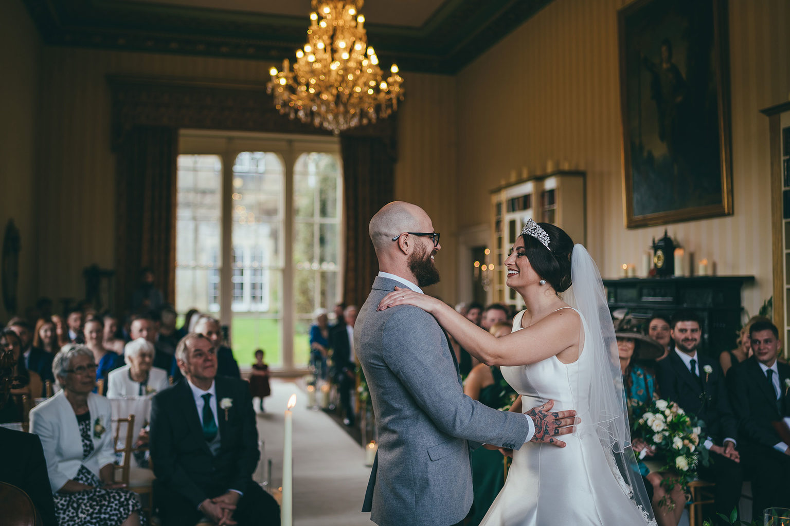 A bride and groom getting married during a castle hotel wedding ceremony at Swinton Park Hotel near Harrogate in North Yorkshire. Photo by Joel Skingle.