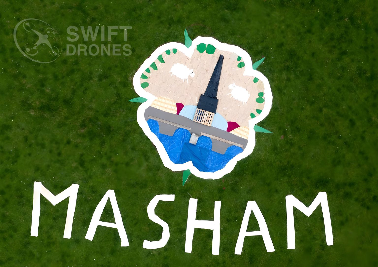 Aerial photo of land art on a field depicting sheep and the town of Masham