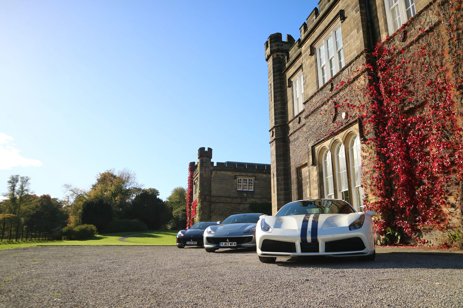 Three supercars parked in front of Swinton Park Hotel for a corporate product launch event in North Yorkshire