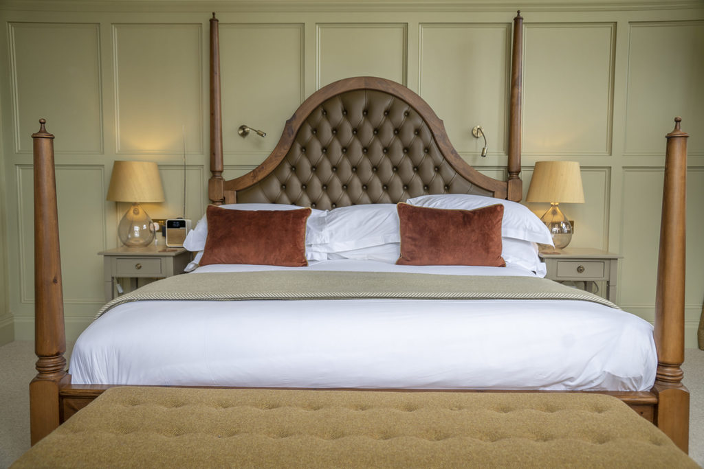 The bed in an opulent, luxury bedroom in the Coach House at Swinton Park Hotel, Masham