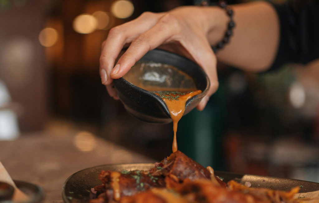 Sauce being poured over food